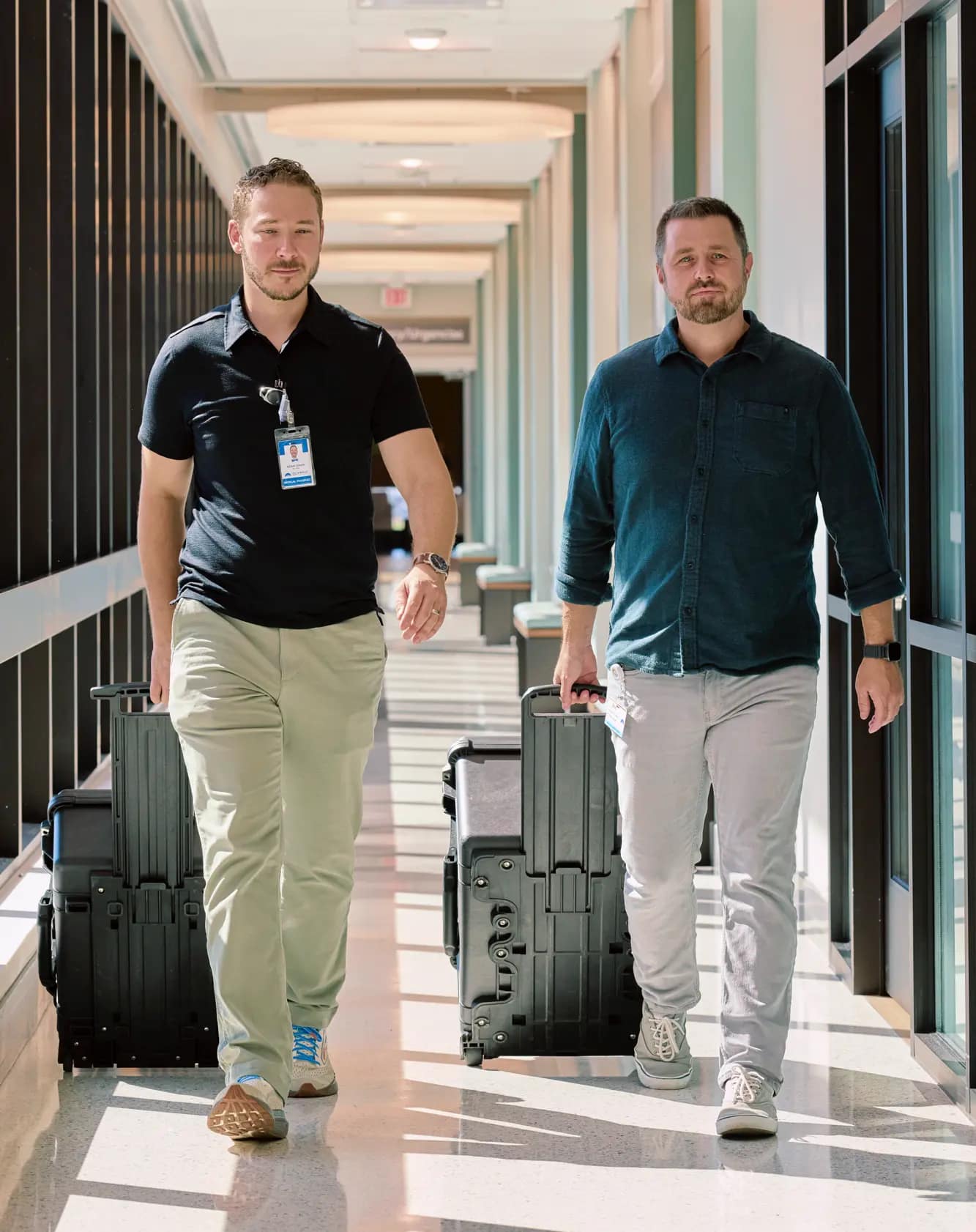 Eric and Adam walking down facility hallway